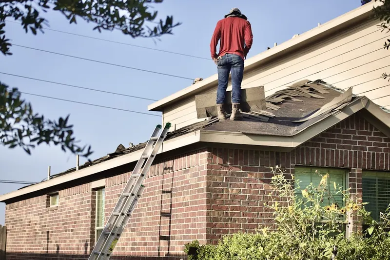 Professional roofer working on a residential roof in Jamestown